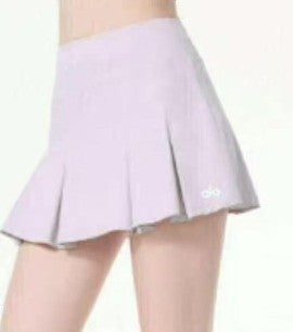 Alo Light purple pleated skirt worn by a person on a white background