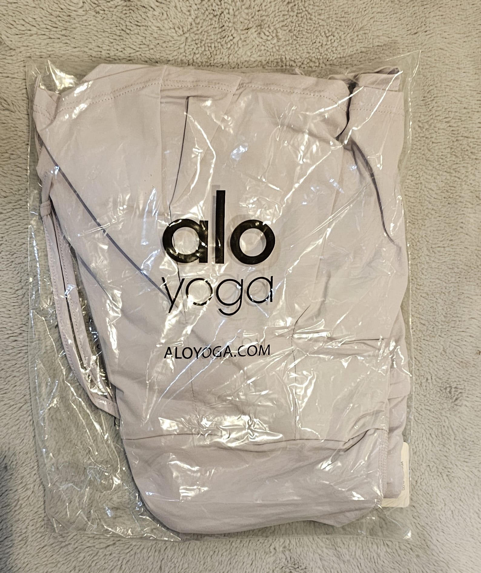 Gray tote bag with 'alo yoga' logo on a light gray background