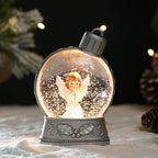 Decorative snow globe with an angel figure 