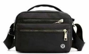 Black lululemon crossbody bag with visible brand logo on a white background