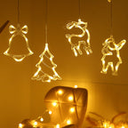 Decorative LED lights shaped like a bell, tree, reindeer, and bear hanging 