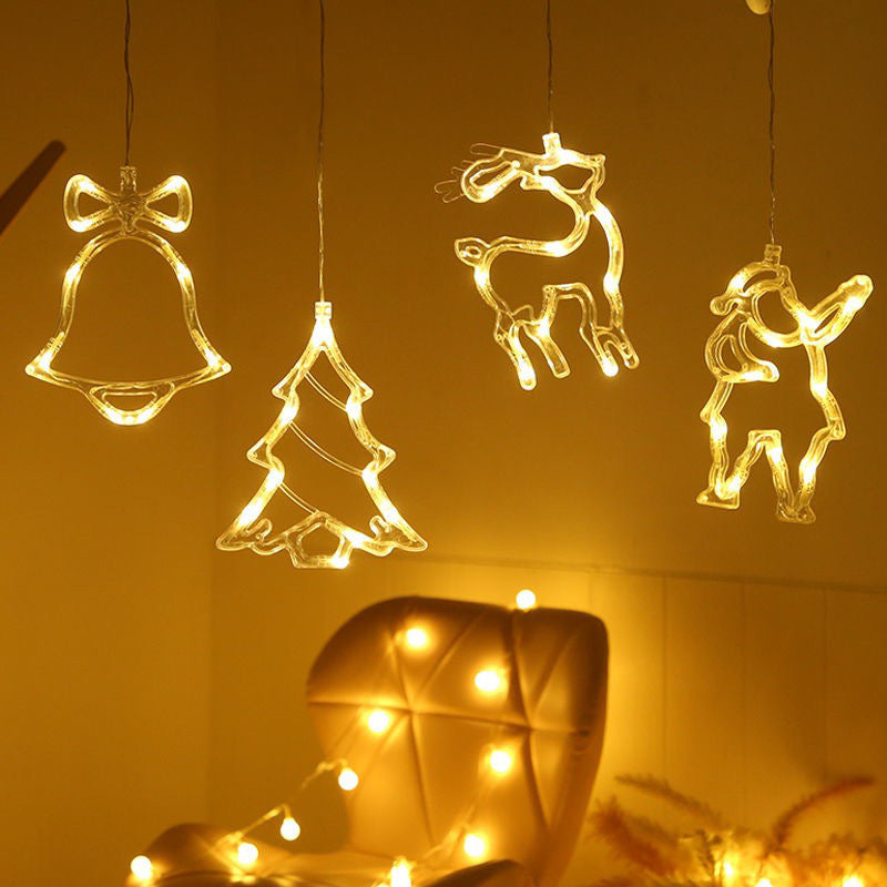Decorative LED lights shaped like a bell, tree, reindeer, and bear hanging 