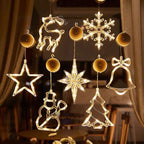 Decorative hanging lights shaped like stars, snowflakes, deer, bells, and trees in a warm glow.