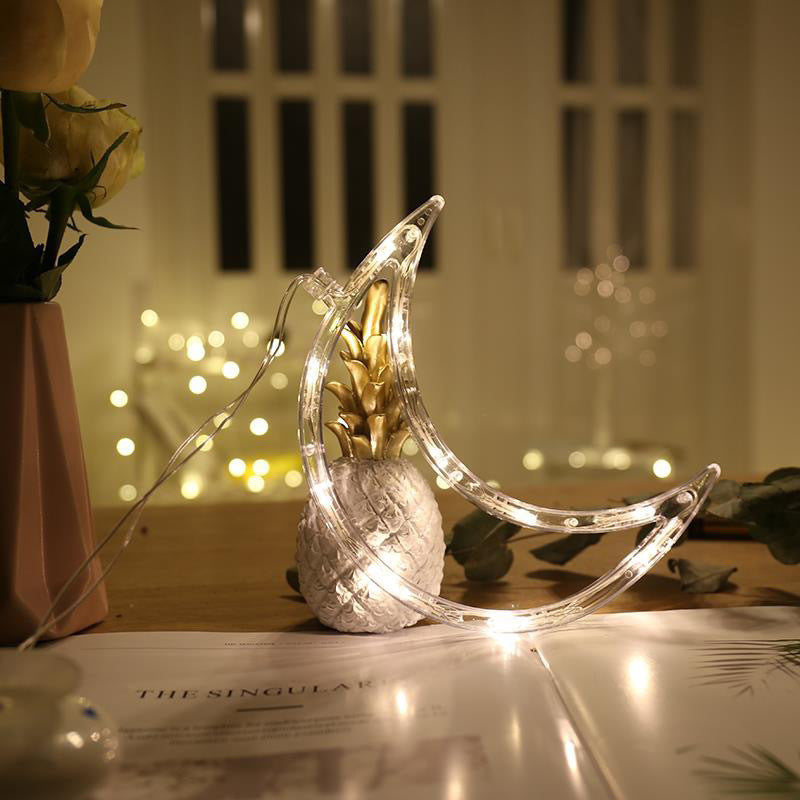 Decorative moon-shaped lamp with string lights 