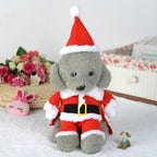 Plush toy dog in a Santa outfit with a white background