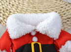Close-up of a red Santa Claus costume with white fur trim on a woven surface.