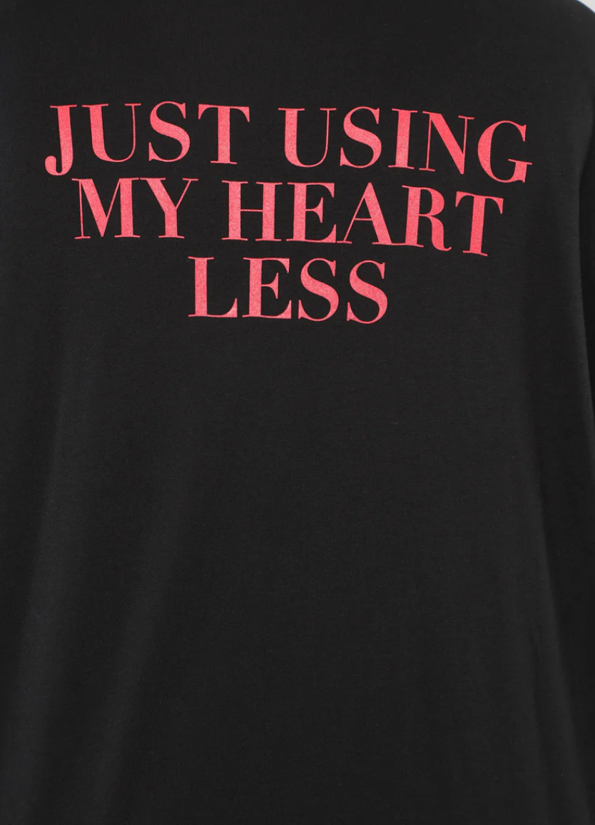 Black Fashion Nova t-shirt with red text 'JUST USING MY HEART LESS' on the back