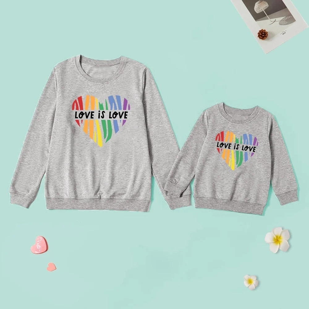 Two gray sweatshirts with rainbow heart design and 'Love is Love' text 