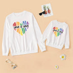 Two white sweatshirts with rainbow heart design and 'Love is Love' text