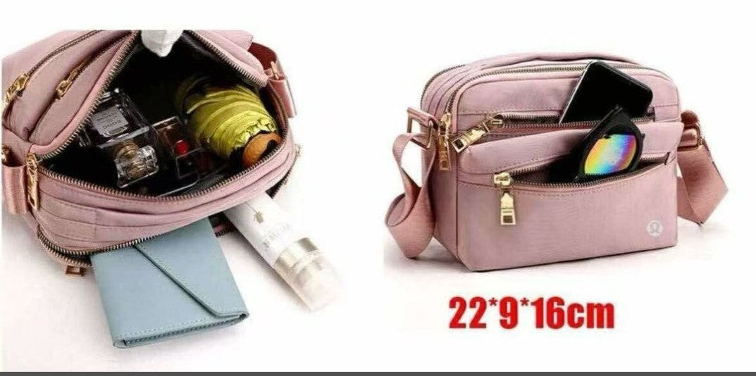 Pink lululemon crossbody bag with compartments and items inside, on a white background.