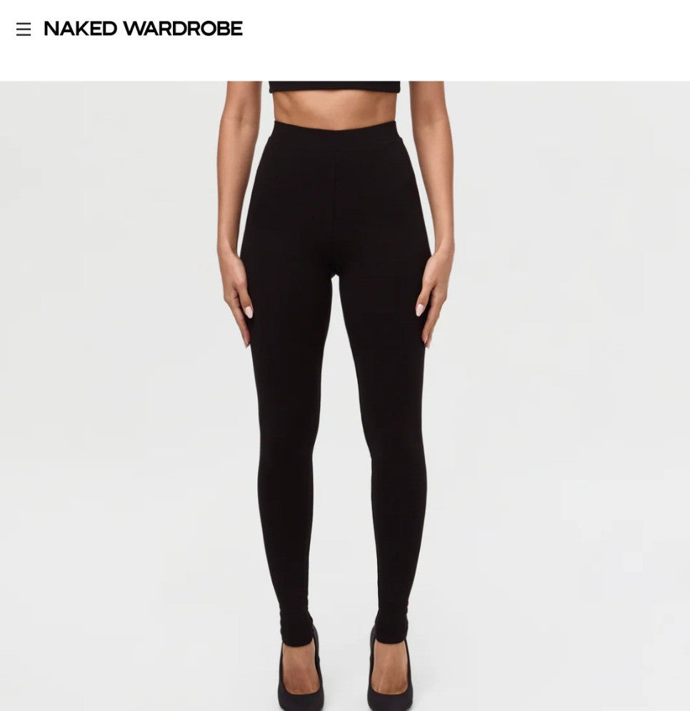 Person wearing black Naked Wardrobe leggings on a white background with 'Naked Wardrobe' branding.