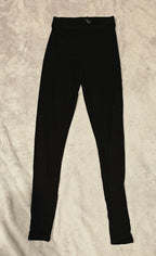 Black Naked Wardrobe leggings on a beige textured surface