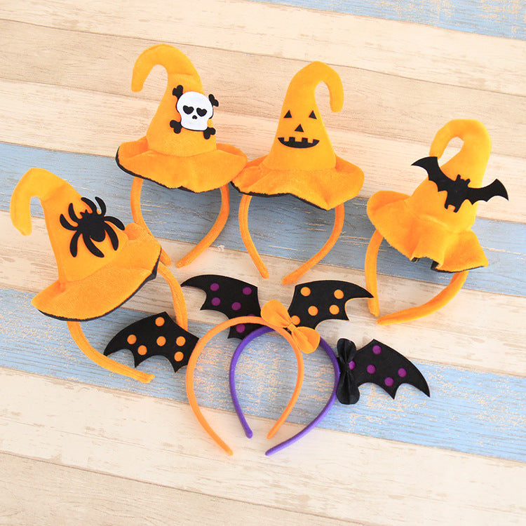 Set of Halloween-themed headbands with pumpkins, bats, and spiders on a wooden surface.