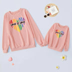 Pink sweatshirts with 'Love is Love' rainbow heart design 